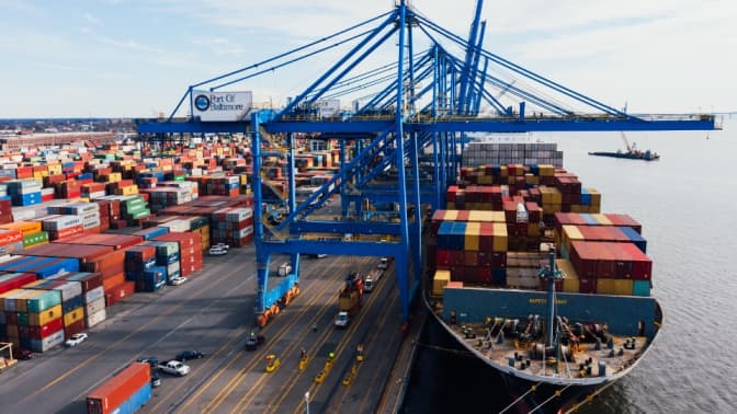 Large container port with cargo ships and loading cranes